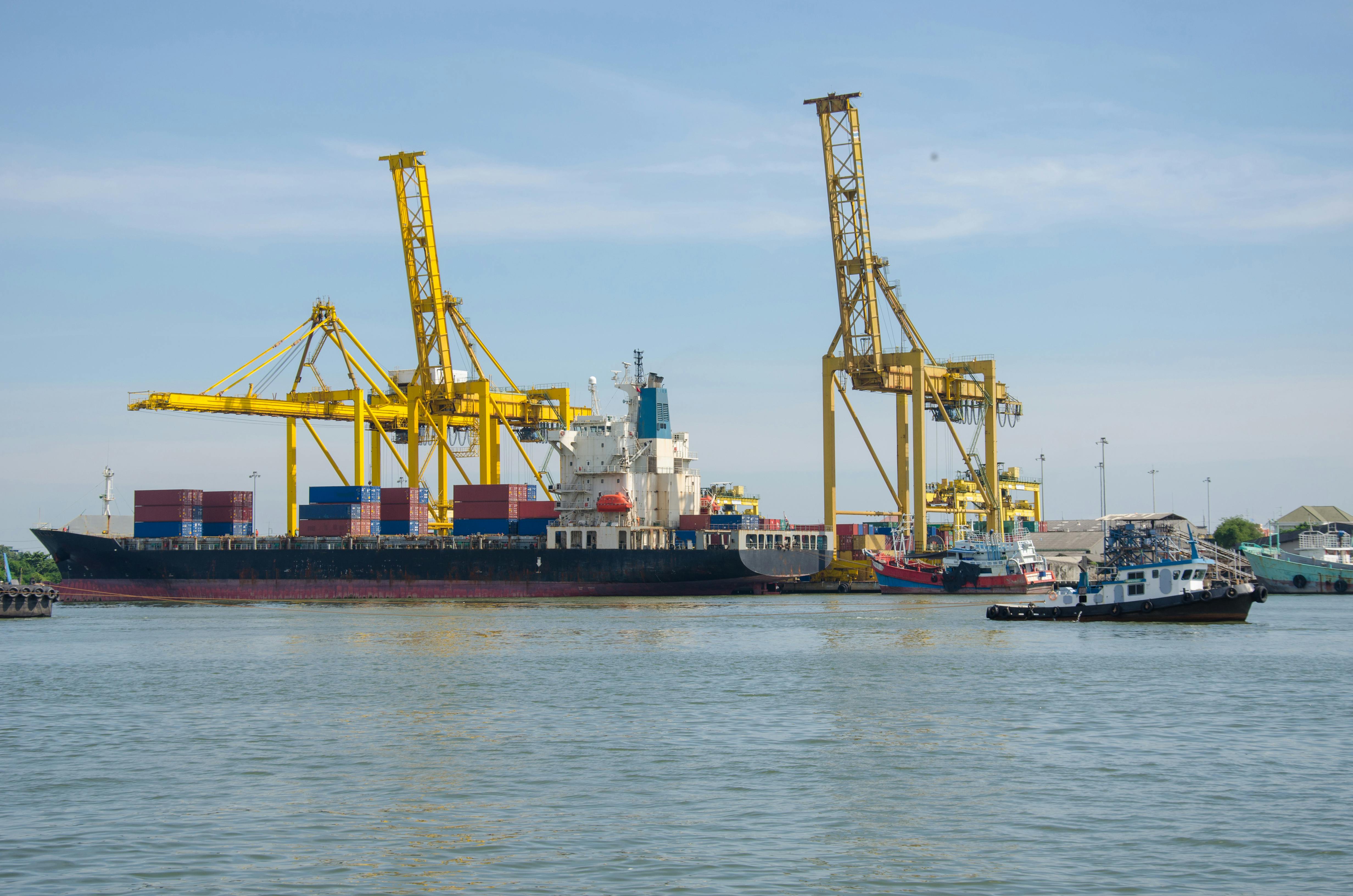 Cargo ship at port with cranes