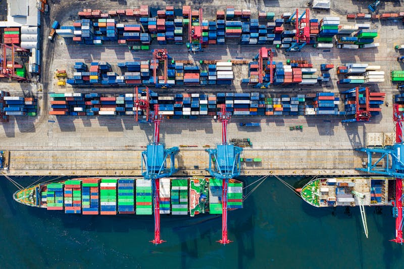 Aerial view of ship loading at port with cranes